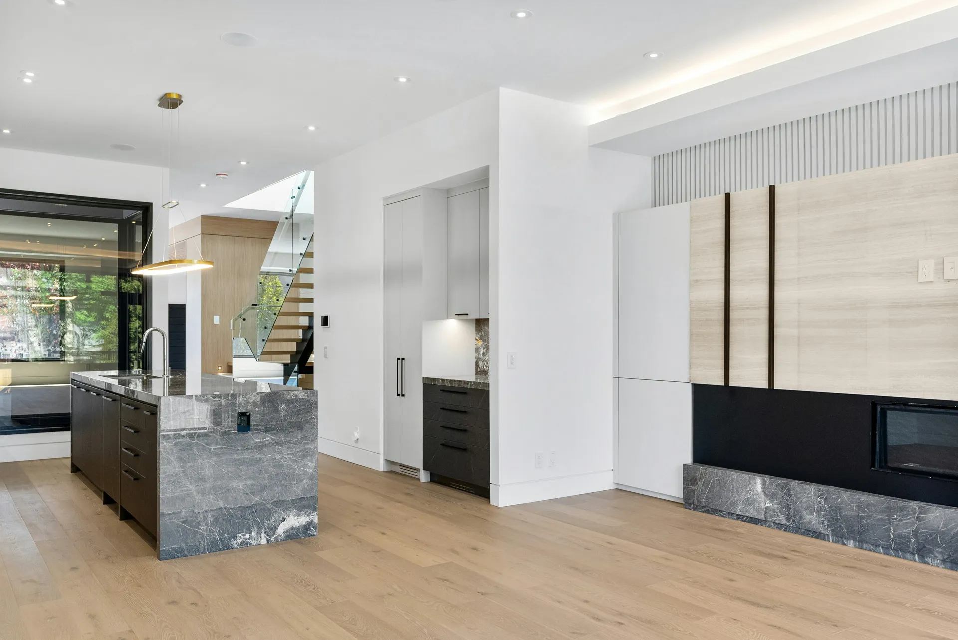 Kitchen with center island, dark cabinets, marble counter, and open space with light
